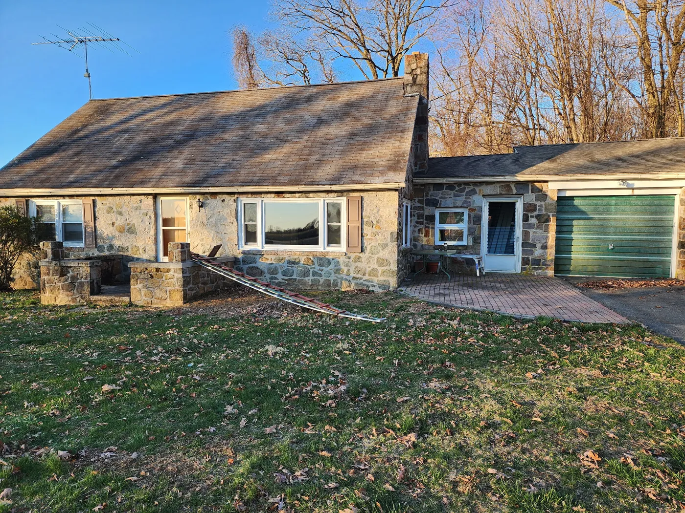 Stone home before window replacement by Go2 Exteriors
